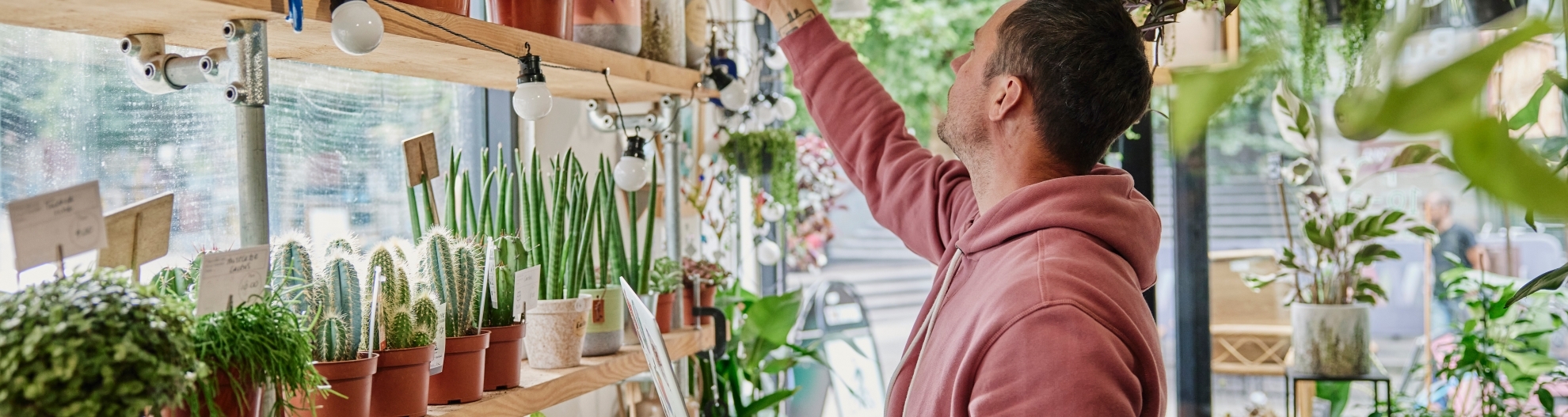 Man using laptop in flower shop